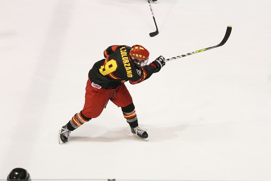 ice hockey player holding black and yellow hockey stick, Winter Sport