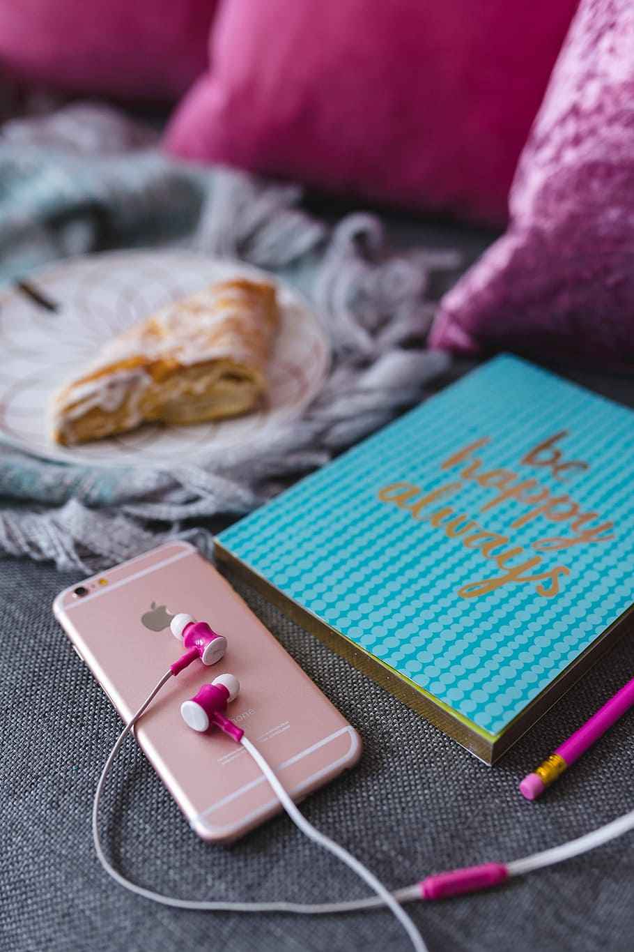 Blue notebook with a pink iPhone, headphones and a sweet bun, HD wallpaper