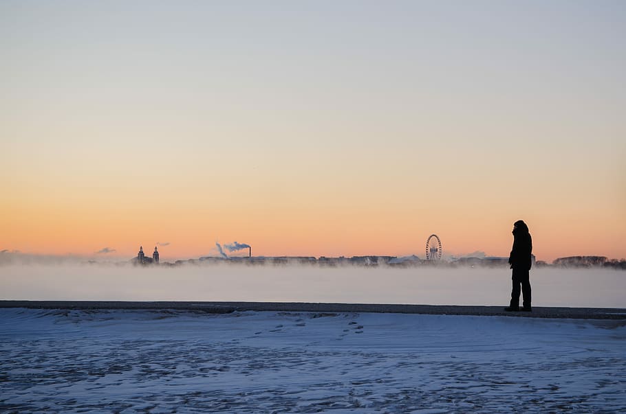 silhouette of person standing on seashore, silhouette of person standing near white field at golden hour HD wallpaper