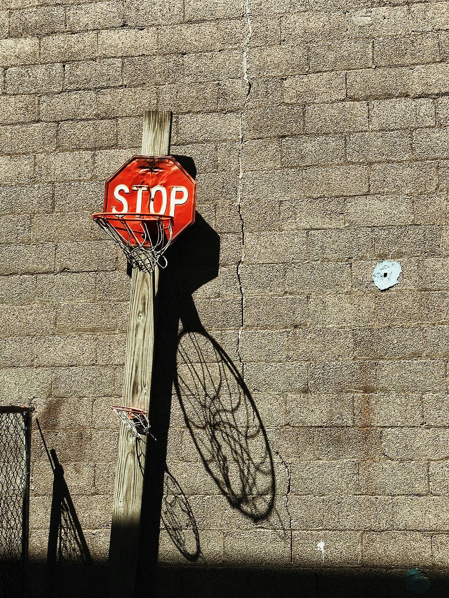 stop road signage basketball hoop, red and brown basketball hoop
