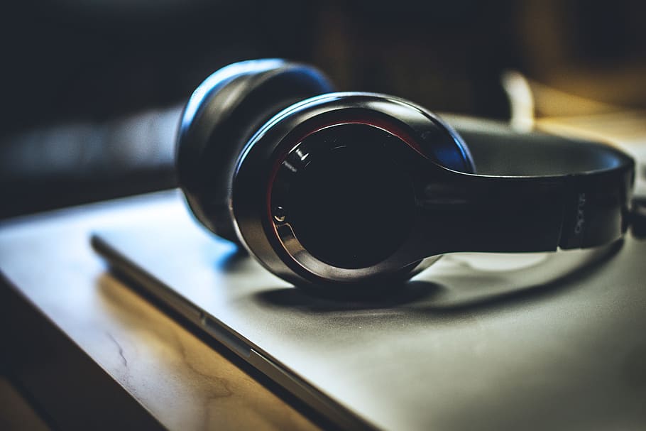 Silver headphones resting on a laptop, technology, music, legal System HD wallpaper
