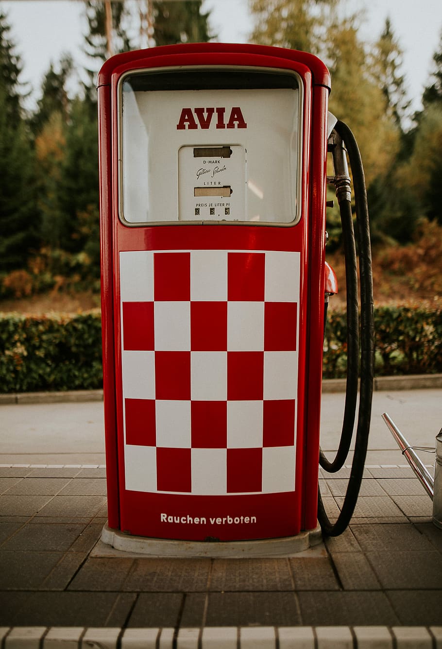 red and white Avia gasoline machine, closeup photo of white and red Avia gasoline dispenser