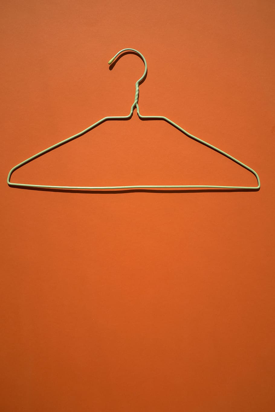 white clothes hanger on orange flooring, closeup photo of gray clothes hanger, HD wallpaper