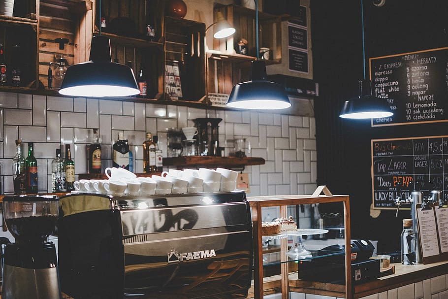 grayscale photo of lighted pendant lamps, wine bottles on table under cabinet HD wallpaper