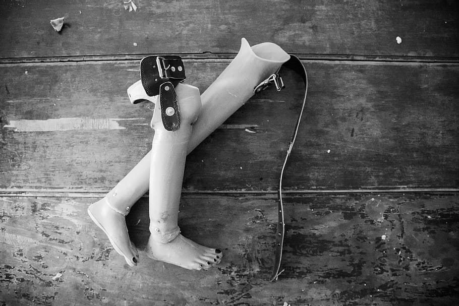 Two Prosthetic Legs on Wooden Surface, abandoned, broken, dark HD wallpaper