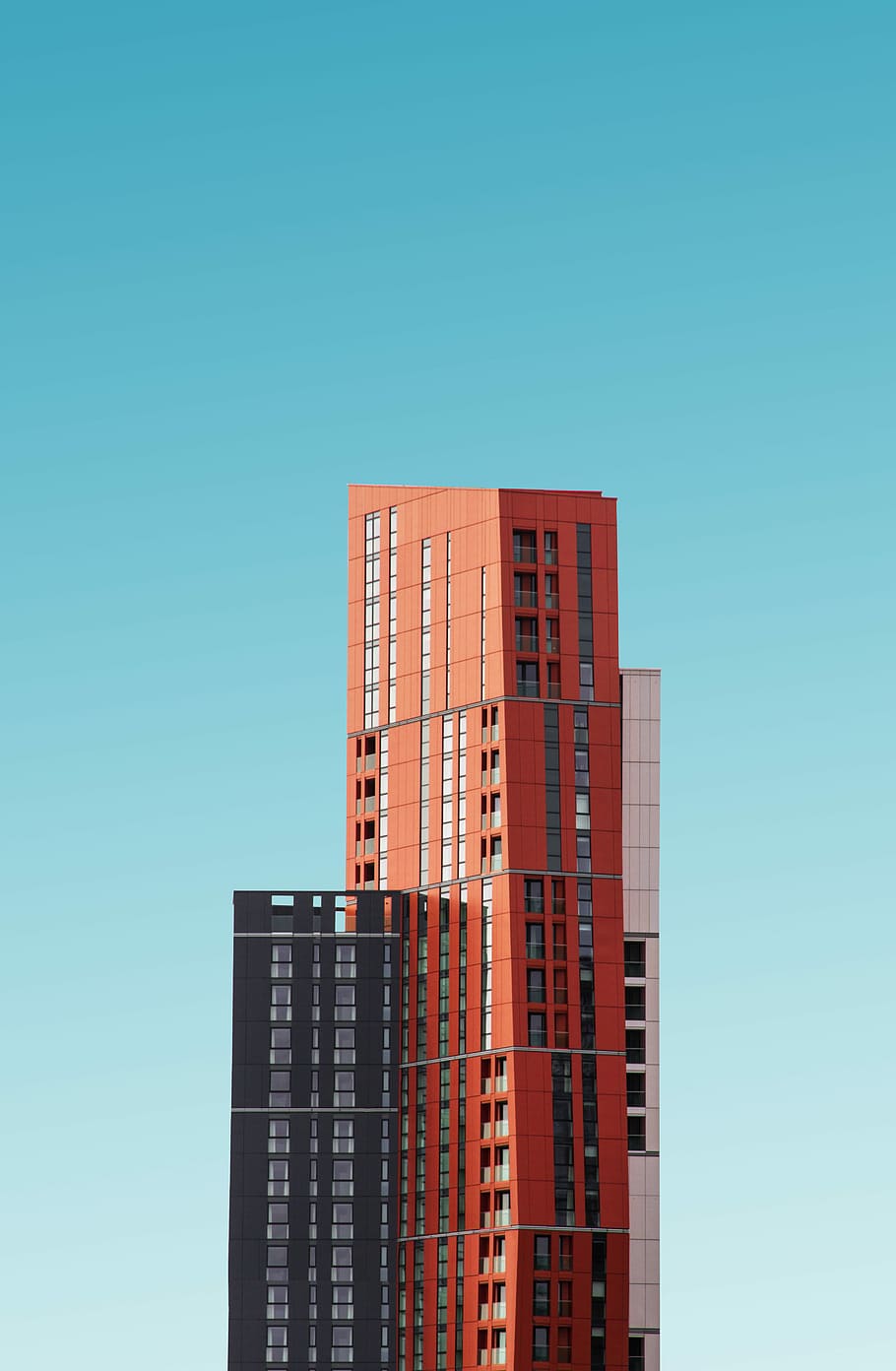 orange and black high rise building, orange and gray building