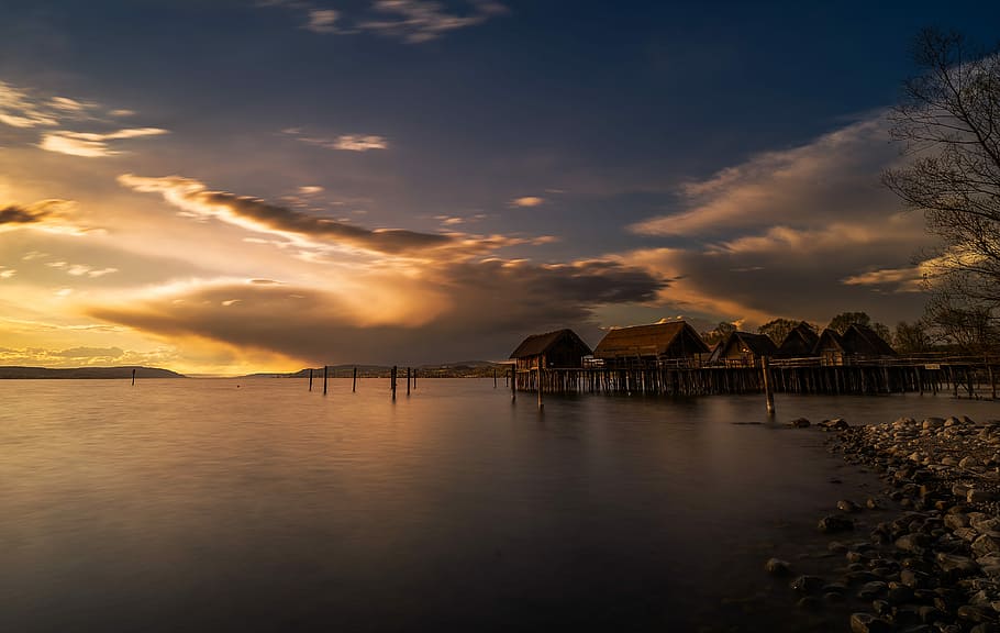 photography of brown cottage on body of water, sunset, waters HD wallpaper