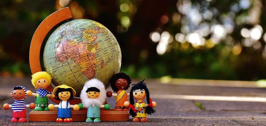 shallow focus on kids plastic toy surrounding desk globe, different nationalities, HD wallpaper