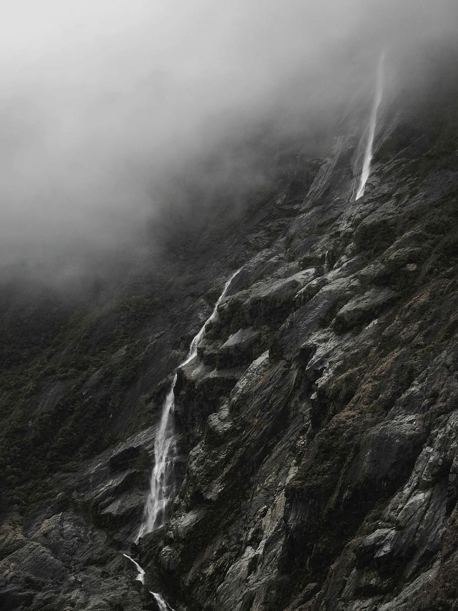 grayscale high-angle photography of rock slope, mountain with waterfalls landscape during daytime HD wallpaper