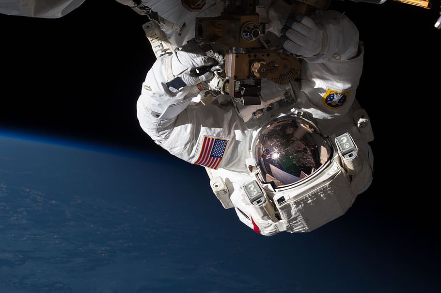 U.S. astronaut on space, spacewalk, iss, tools, suit, pack, tether