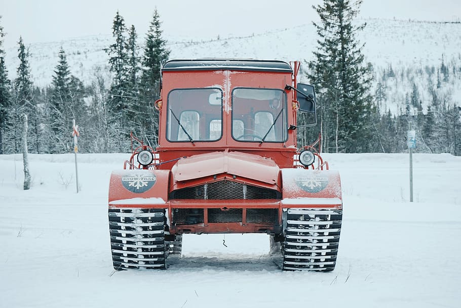 red vehicle passes on road coated snow, red tractor on pathway coated snow HD wallpaper