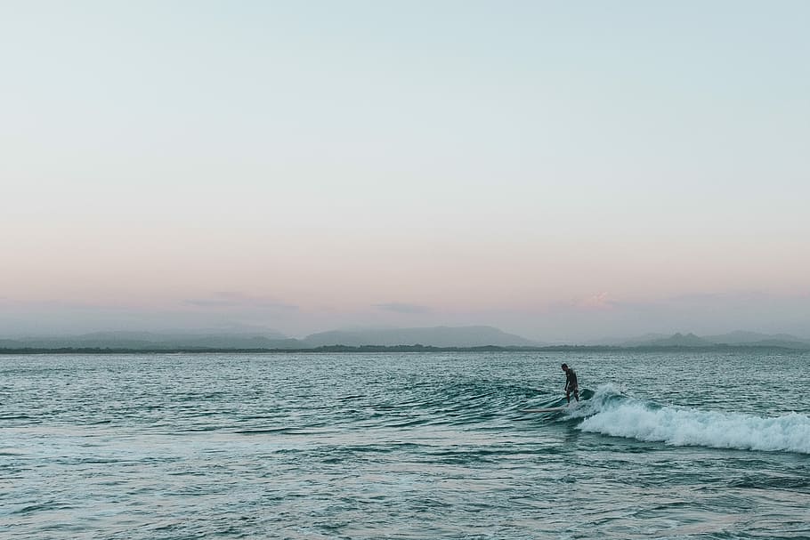 person surfing during golden hour, person surfboarding during daytime HD wallpaper