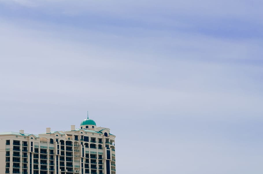 landscape photography of high rise building, white and green concrete building under white clouds at daytime HD wallpaper