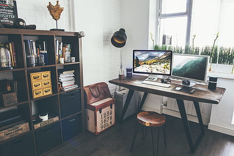 two flat screen monitor turned on near organizer rack inside the room, brown wooden desk near cube organizer HD wallpaper