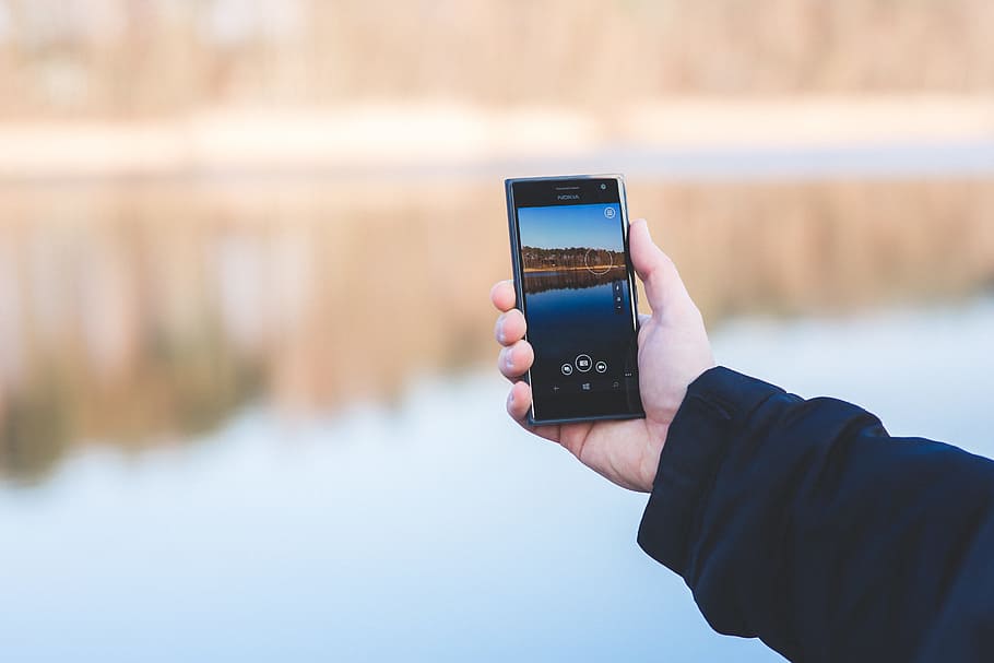 Man taking photo of a lake with mobile phone, hand, screen, smartphone HD wallpaper
