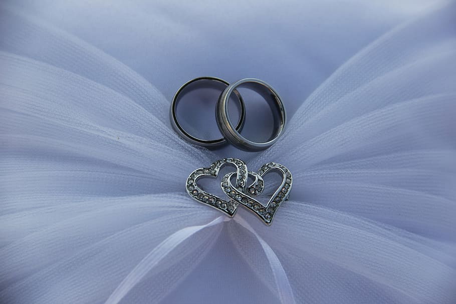 Premium Photo | Pair of platinum wedding rings glitter background ai  generated