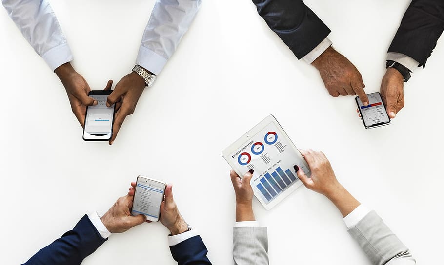 top view photo of three four person holding mobile gadgets HD wallpaper