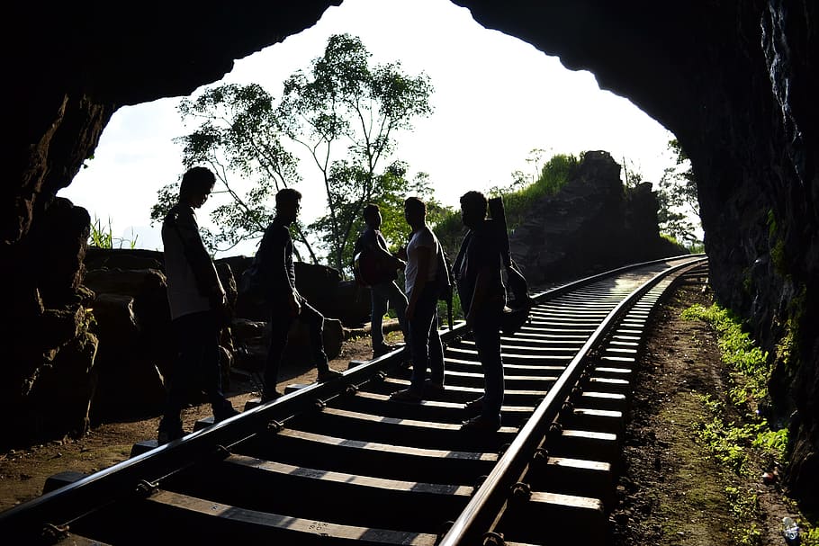 five persons standing on railway inside tunnel, boy, boys, men