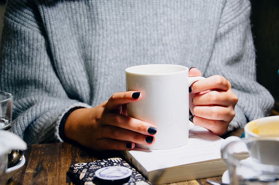 woman holding white ceramic mug near table, white mug, cup, drink HD wallpaper