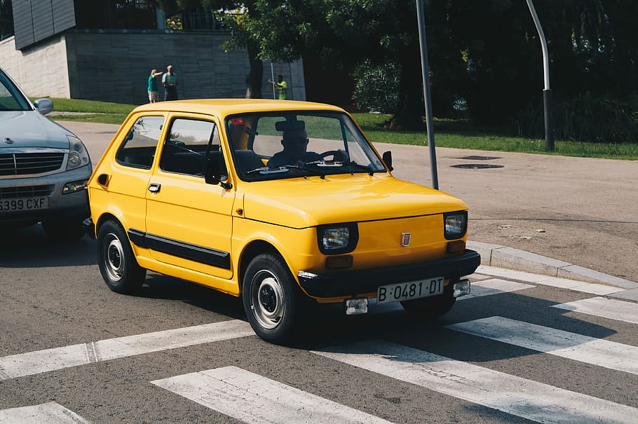 yellow car on concrete road during daytime, yellow 5-door hatchback on road HD wallpaper