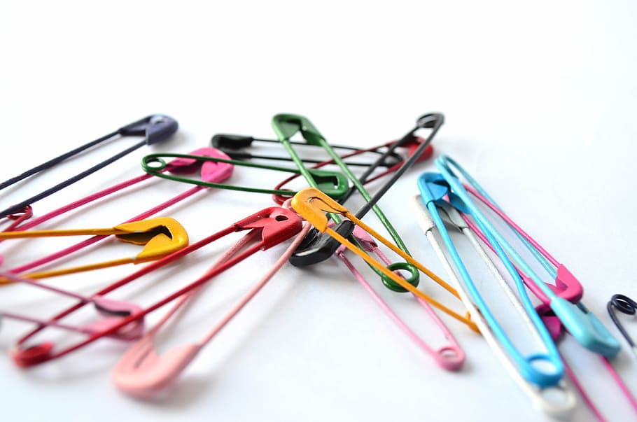 multicolored safety pin lot on white surface, fixing pin, pins
