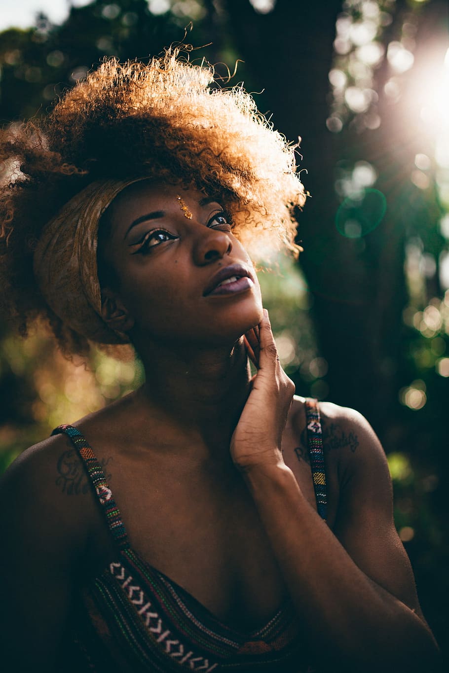 woman in tribal print tank top near trees, bokeh photo of woman holding her chin HD wallpaper