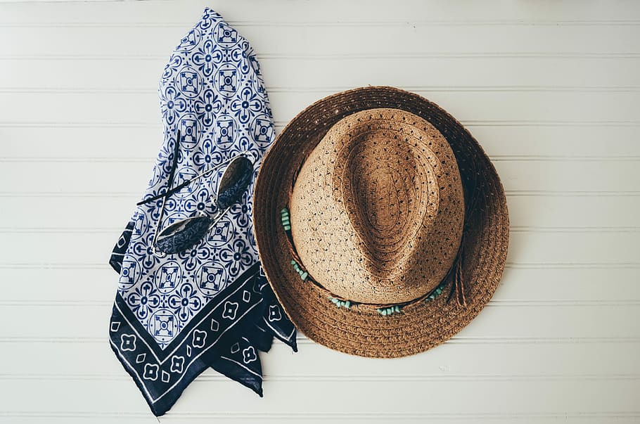 brown hat beside black handkerchief, brown fedora hat beside white and black towel HD wallpaper