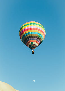 multicolored hot air balloon under blue sky, low angle photography of hot air balloon during day time HD wallpaper