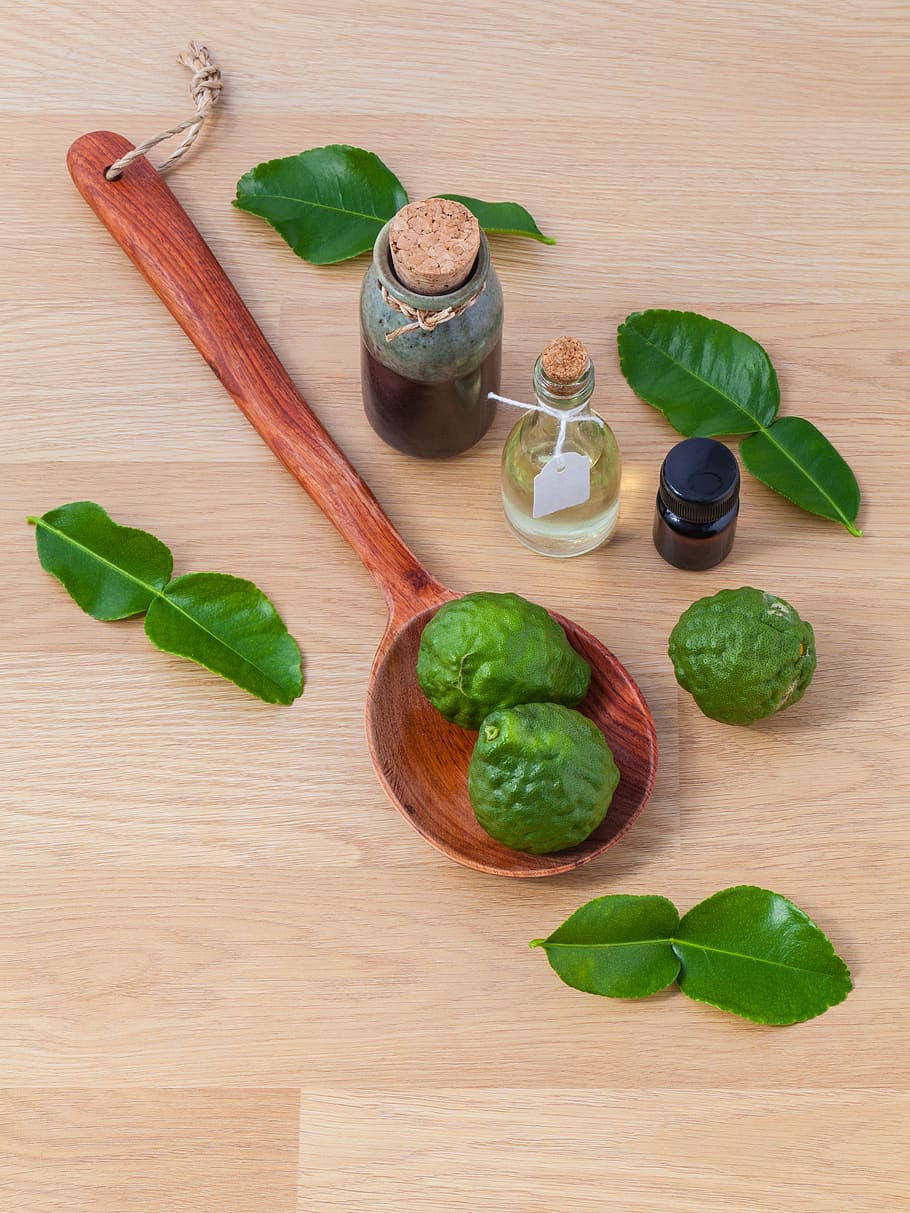 two green fruits on spoon near vials, alternative, aromatherapy, HD wallpaper