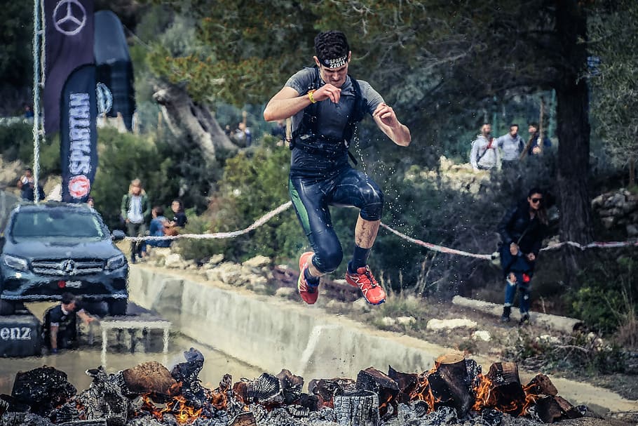 man jumping on flaming charcoal, man jumped over charcoal with fires HD wallpaper