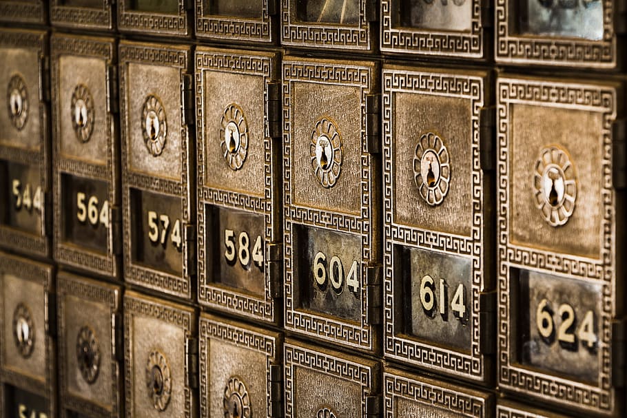Numbers on metal deposit boxes in a bank, close-up photo of brown locker