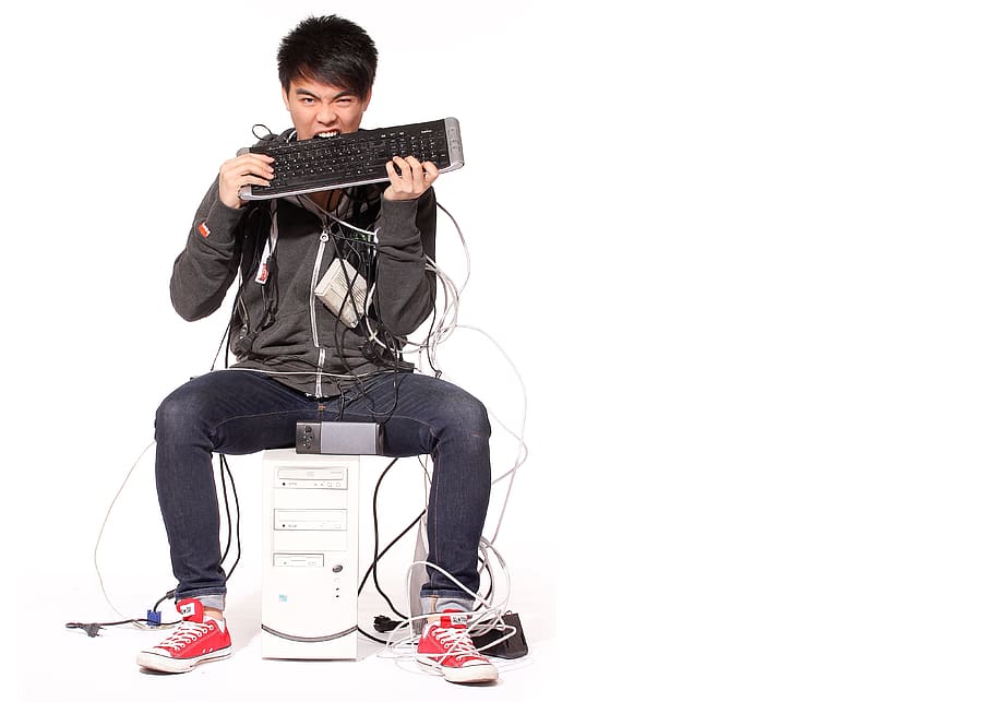 man in black hoodie biting keyboard, pc, computer, internet, networking