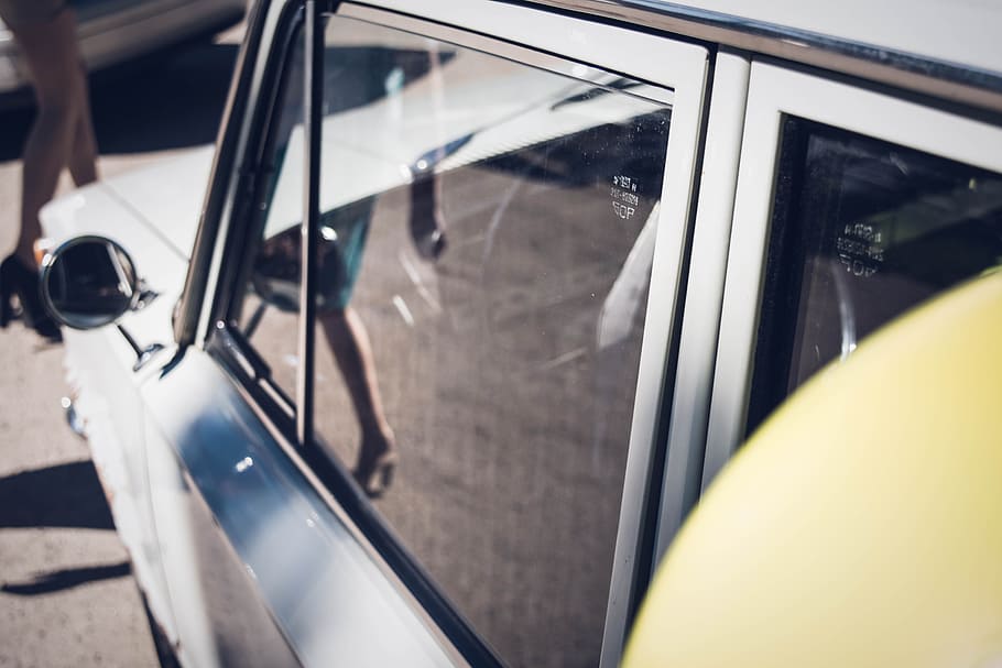 Woman seen walking in the reflection of a car window, classic white car HD wallpaper