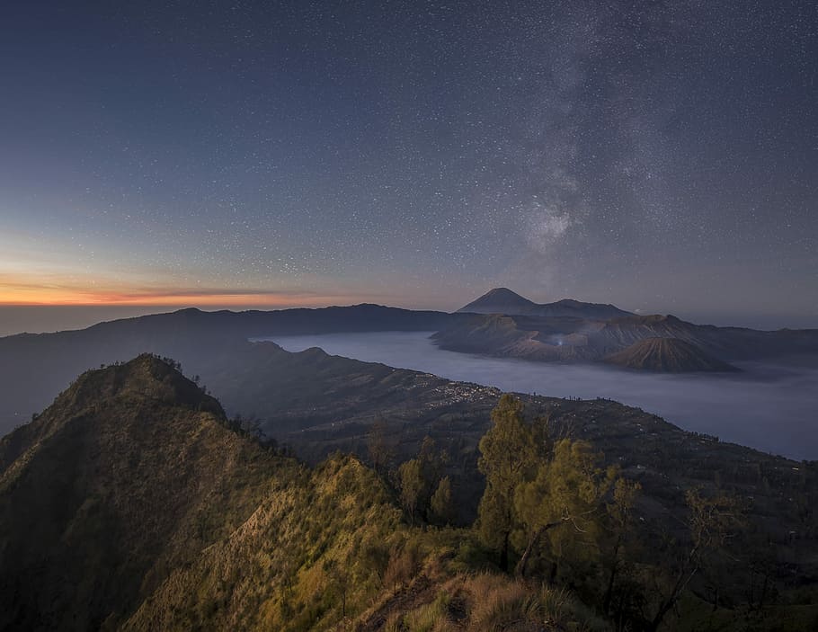 Lost in Bromo, mountain and body of water under gray sky during golden hour HD wallpaper
