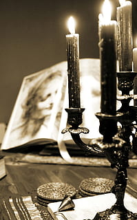sepia photography of lighted candles with candelabra near open books HD wallpaper