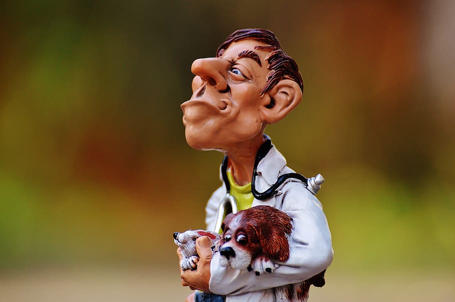 man holding rabbit and dog themed figurine selective focus photography