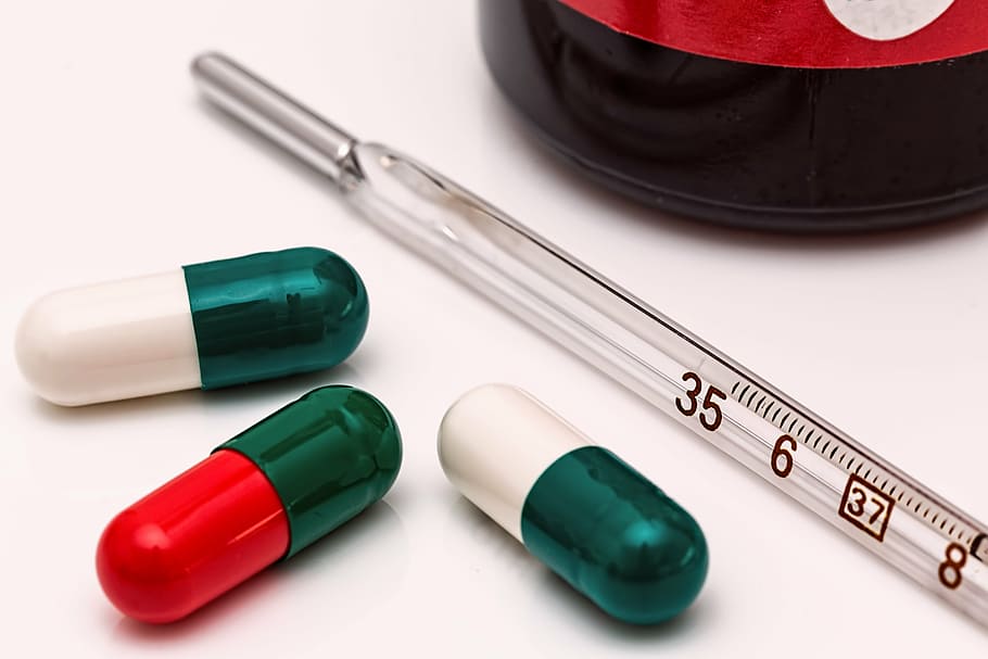 person taking photo of three medication capsules with thermometer, HD wallpaper