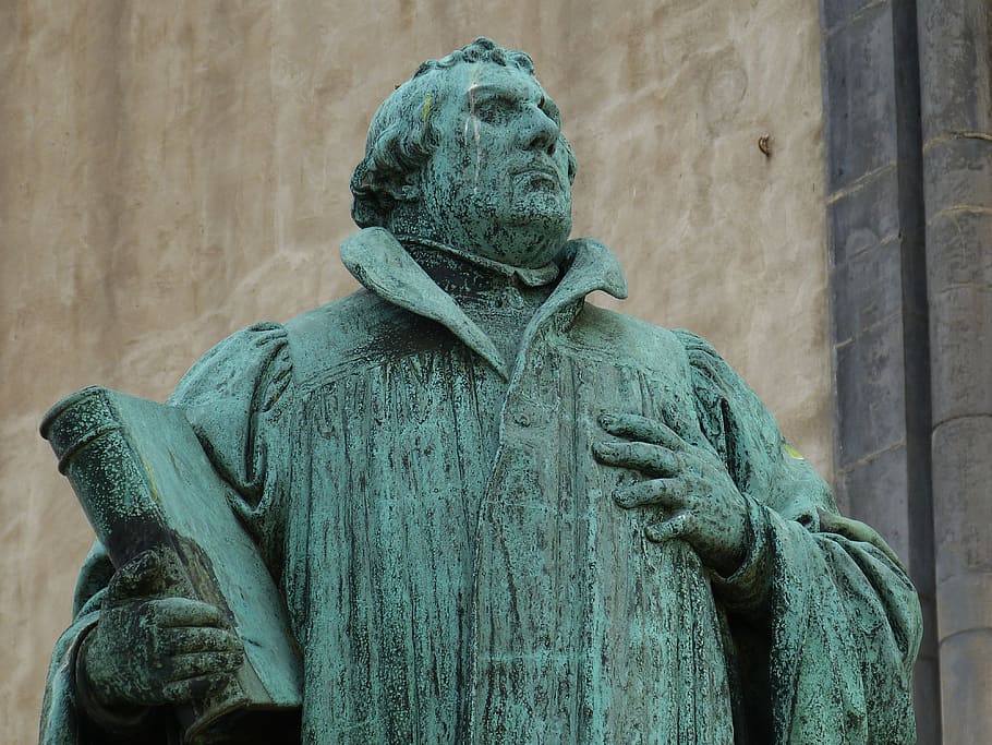 teal concrete statue of man, martin luther, protestant, monument