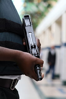 selective focus photo of person holding SMG, agent, armed, armour HD wallpaper
