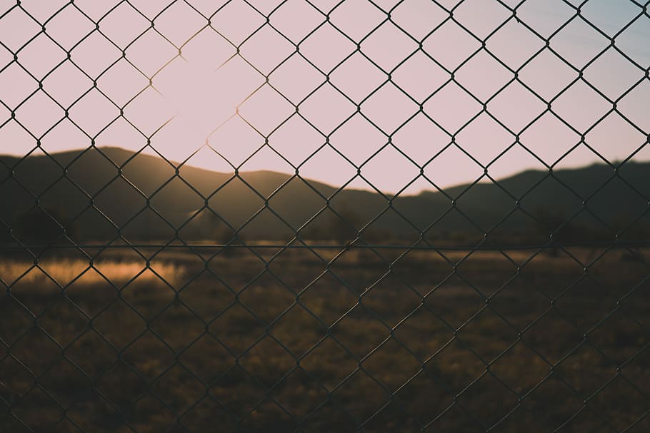 silhouette photography of chain-link fence, shallow focus photography of cyclone fence during daytime HD wallpaper
