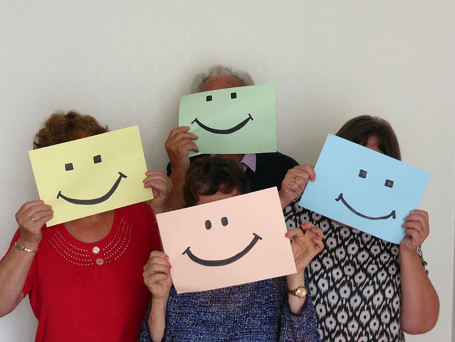 group of people holding smiley illustrations, optimism, welcome, HD wallpaper
