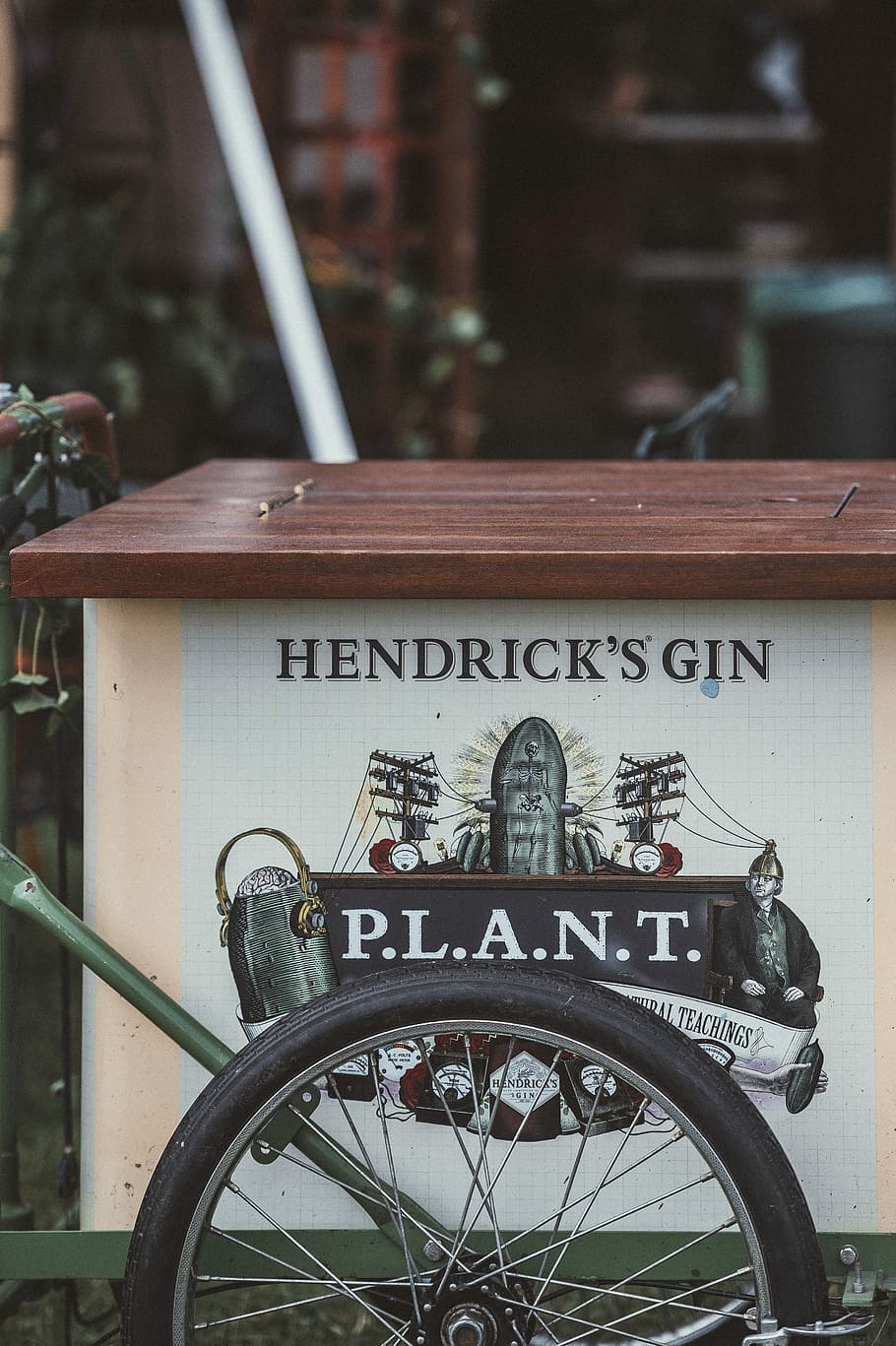 Hendrick’s Gin, brown wooden storage, cart, wheel, spokes, text HD wallpaper