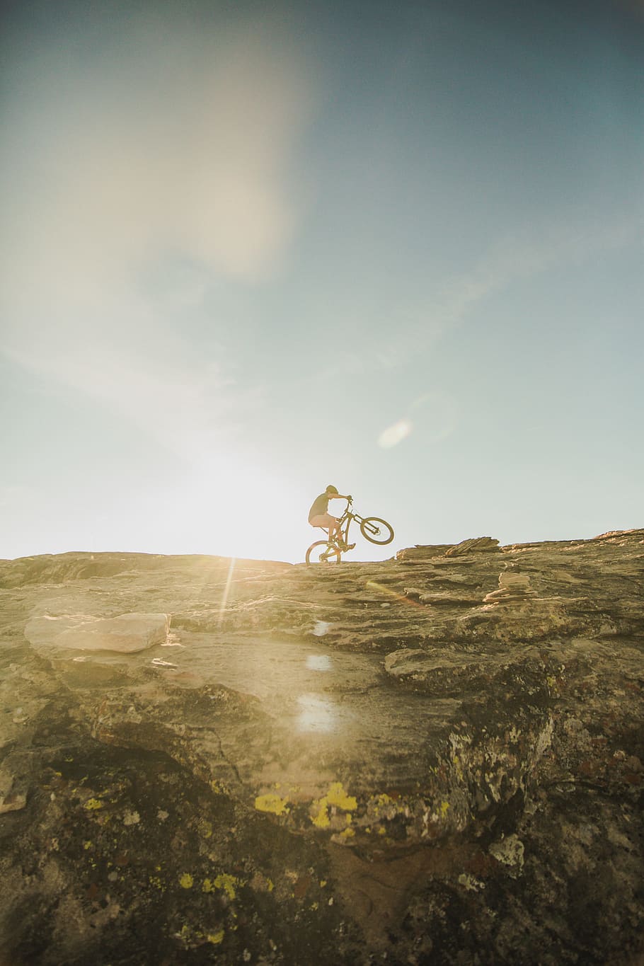 person riding on bicycle, man cycling on mountain, bike, stone