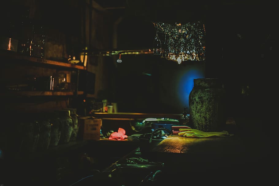 turned on pendant lamp over vase and shelf, green vase beside gloves on table HD wallpaper
