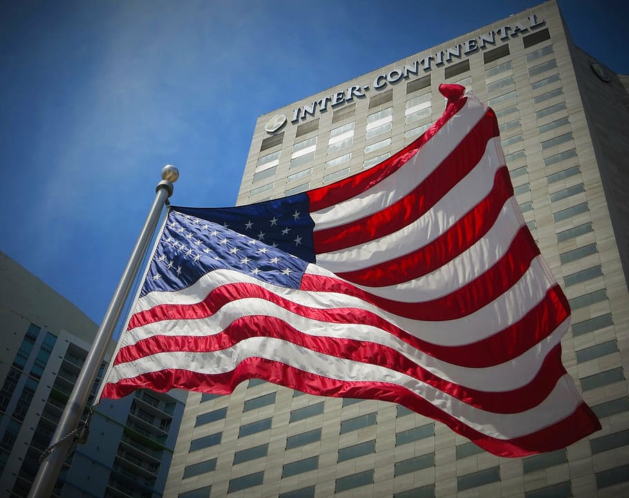 flag of United States of America in front of Inter-Continental building HD wallpaper