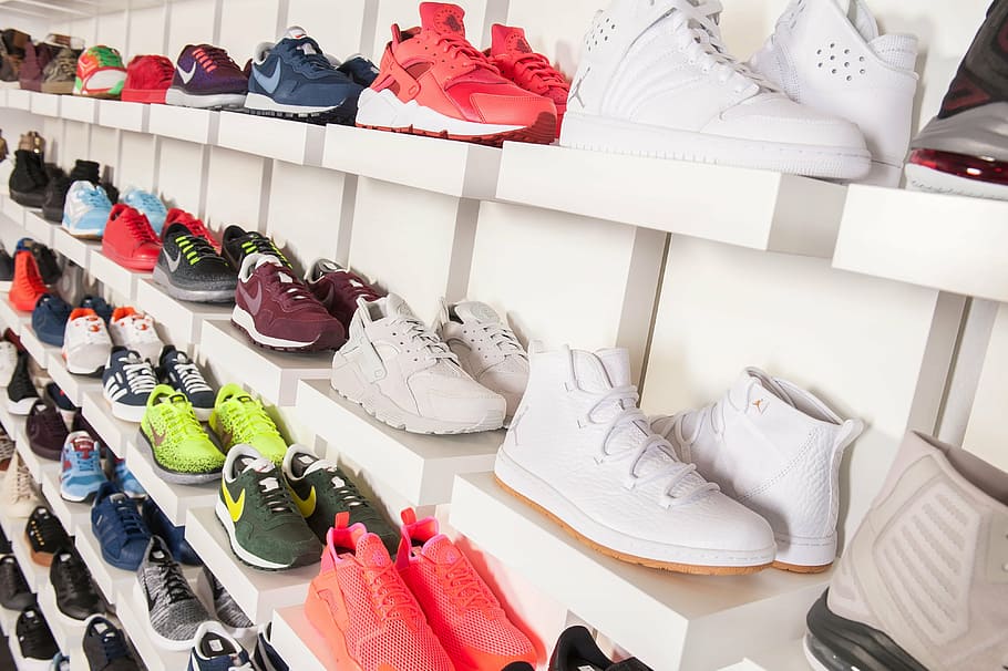 pair of assorted-color sneakers on shelf, school aden, shoes