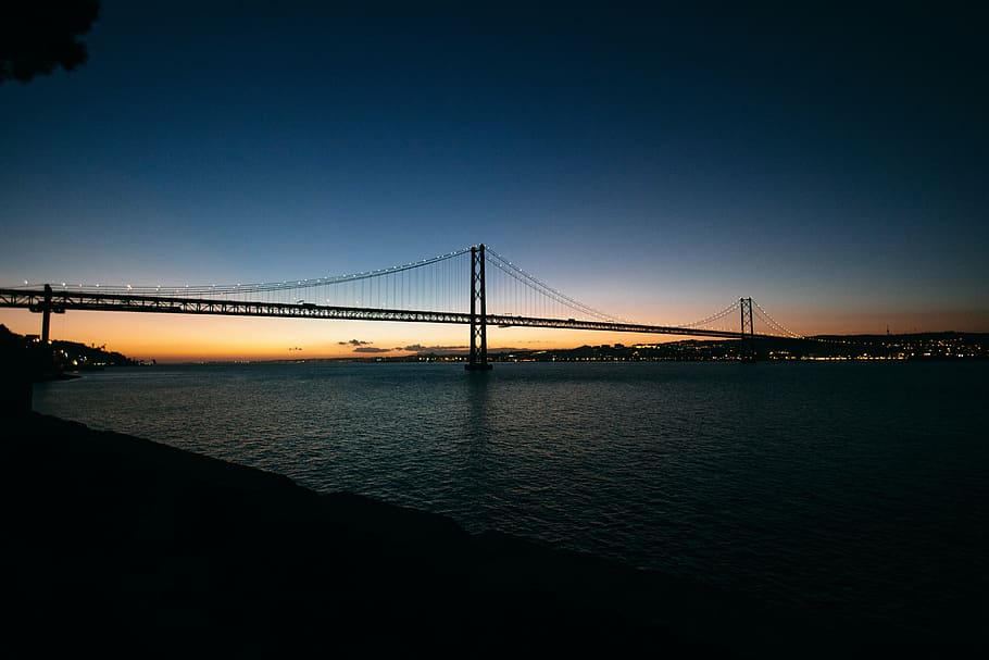 black suspension bridge on sea taken during night time, dark HD wallpaper