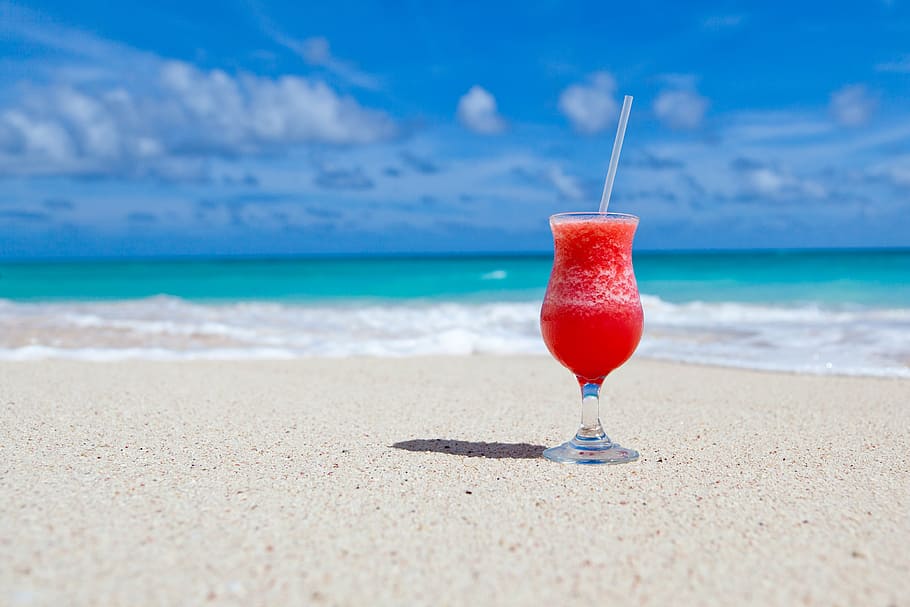 red and black glass vase, clear footed glass cup filled with smoothie on seashore, HD wallpaper