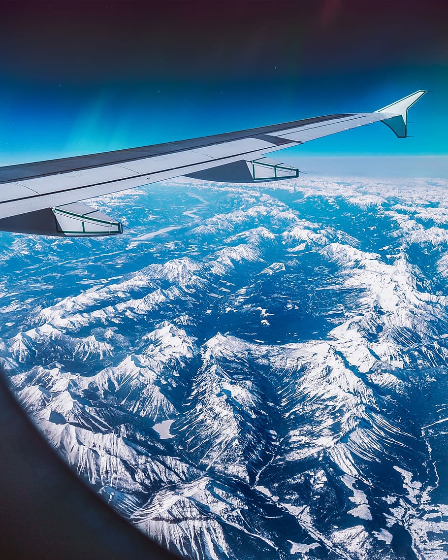 airplane over mountain ridges, low-angle photography of hill at daytime HD wallpaper