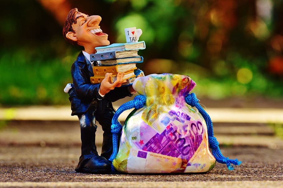 man carrying books figurine, taxes, tax consultant, finance, money